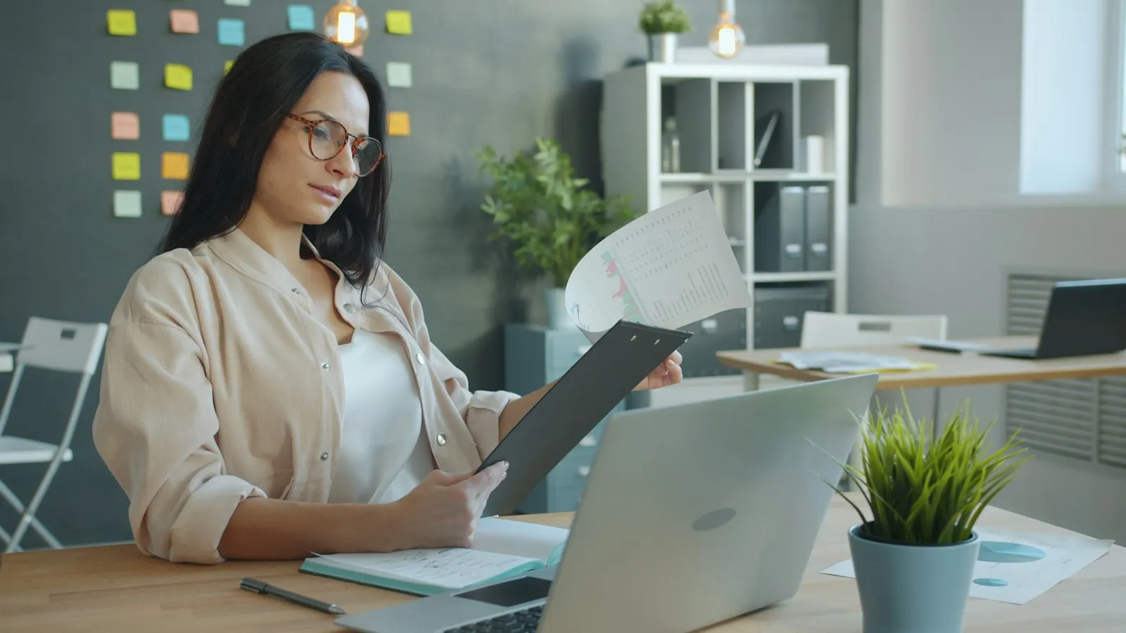 Mujer revisando reportes contables en su escritorio para el cierre del año